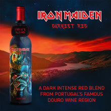 Load the picture into the gallery viewer, Iron Maiden Darkest Red wine bottle, Eddie’s Blend, set against a stunning sunset over Portugal’s Douro wine region, highlighting its dark, intense red blend.
